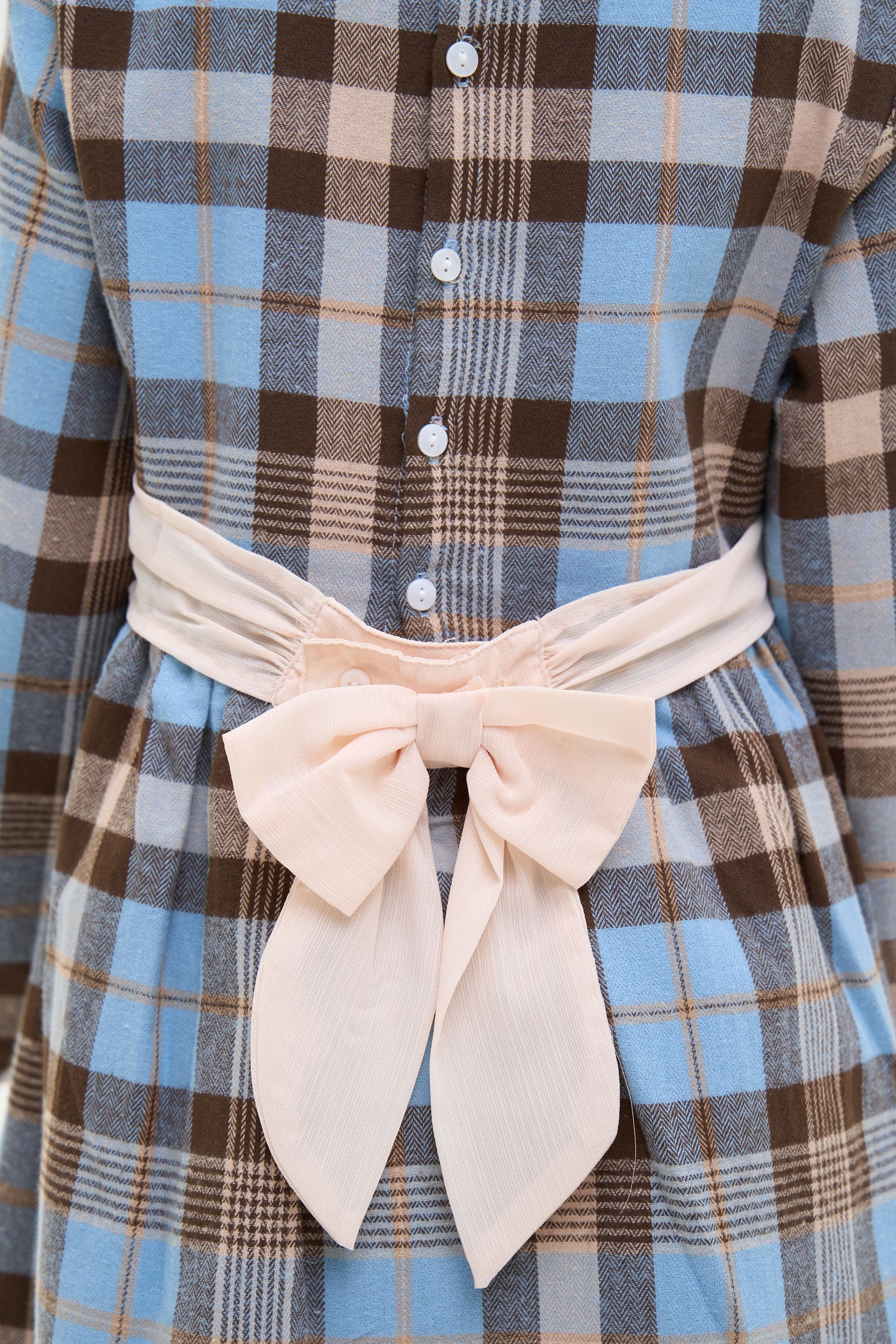 Stylish children's dress with long sleeves, plaid